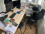 a desk with two monitors and a keyboard on it