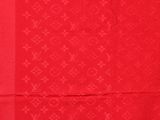 a close up of a red scarf with a pattern on it