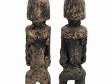 two stone statues on a wooden stand on a white background