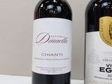 two bottles of wine sitting next to each other on a table