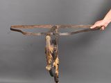 a person holding a piece of wood with a knife in it