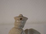 a small figurine of a man riding a horse