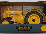 a box with a toy tractor in it on a table