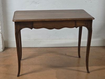 a small wooden table with a drawer underneath it
