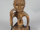 an old wooden statue of a man with a hat on his head