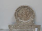 a stone sculpture of a head on a stand
