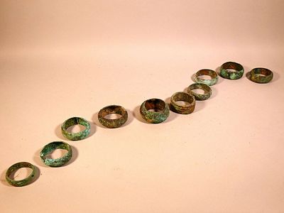 a long line of rings on a table with a white background