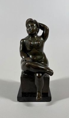 statue of a woman sitting on a stool with her hand on her head