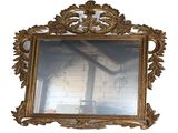 a mirror that has a gold frame on it