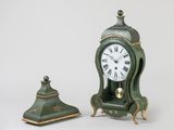a small green clock sitting next to a smaller green clock