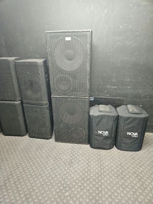 many speakers and bags sitting on the floor next to each other