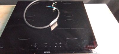 a black stove top with a wire on top of it