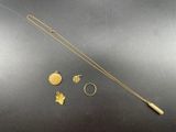 a close up of a necklace, ring, and other items on a table