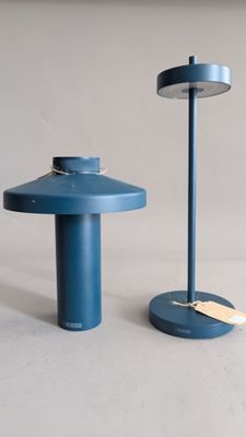 two blue tables that are sitting next to each other