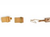 two pairs of gold cufflinks and a gold tie bar