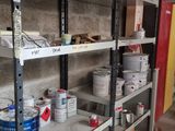 many shelves with paint and cans of paint on them