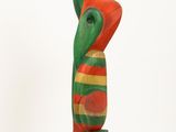 a colorful statue of a bird on a white base