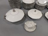 a lot of plates and cups and saucers on the table