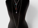 a mannequin with multiple necklaces on it