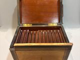 a wooden box that has a bunch of cigars in it