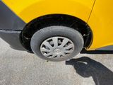 a yellow car that has a flat tire on it