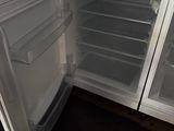an open refrigerator with its door open in a kitchen