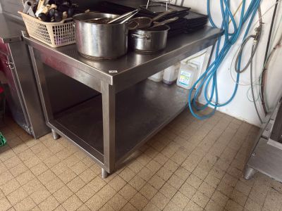 pots and pans sitting on a stainless steel table