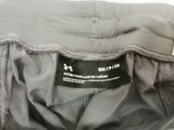 the back of a pair of gray pants with a black label on it