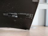 a laptop computer sitting on top of a wooden table