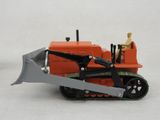 a toy tractor with a man sitting on top of it