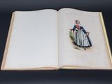 an open book with a drawing of a woman in a blue dress