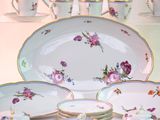 a lot of plates and cups that are on a table