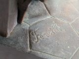 a close up of a statue of a person on a bench