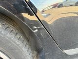 a close up of a car ' s tire with a reflection on the side of it