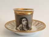 a cup and saucer with a picture of a woman on it