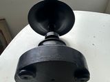 a black object on a white table near a window