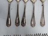a lot of silver spoons and forks on the table