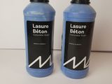 two bottles of blue liquid sitting next to each other on a table
