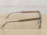 glasses on a wooden table with a white wall in the background