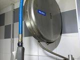 a blue hose attached to a wall in a bathroom