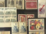 a lot of stamps that are on display on the wall