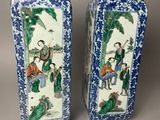pair of chinese blue and white vases with figures on them