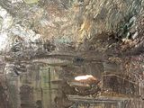 an image of a cave with water and rocks in it