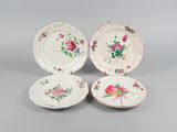 three plates with floral designs on them sitting on a table
