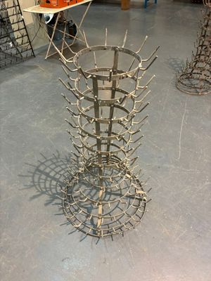 a metal sculpture of a bunch of spikes on the floor