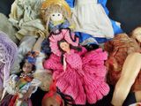 a pile of dolls that are sitting on a table