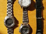 three watches sitting on a table next to each other