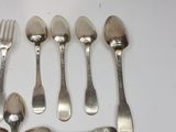 several spoons, forks and spoons laid out on a table