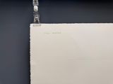 a piece of paper hanging on a clothes line
