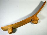 an old wooden skateboard on a white surface